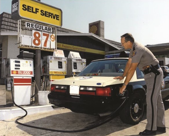 Highway Patrol officer filling up mustang at 87 cents per gallon