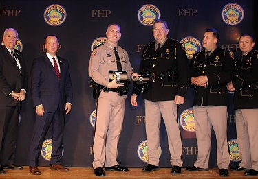 Six Florida Highway Patrol state troopers were recognized as the 7th annual FHP Awards Banquet for making the 'DUI 100,' those who arrested 100 or more in 2022 for impaired driving. Pictured, L-R: FHP Advisory Council President Steve Barnett, FLHSMV Director Dave Kerner, Trooper Scott Mills, Trooper Kenneth Montgomery, Trooper Taylor Ledford, Trooper Jordan Capela, Trooper Joseph Farley, Trooper Garrett Earlywine, FHP Director Colonel Gene Spaulding.