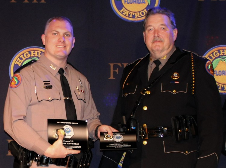 Florida Highway Patrol Trooper Scott Mills accepts the 2022 Hurd-Smith Award from Colonel Gene Spaulding, recognizing Mills for the top DUI arrest total in 2022 with 181.