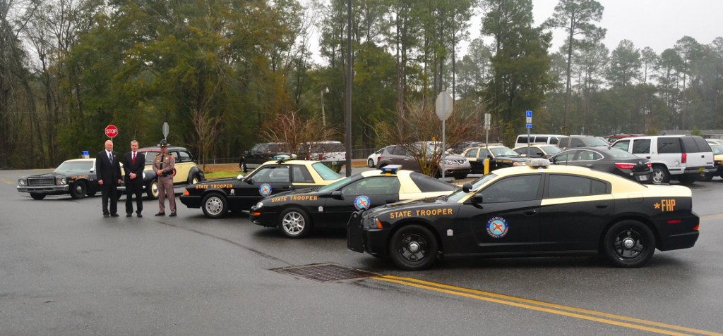 David Neil Kirkman next to trooper cars