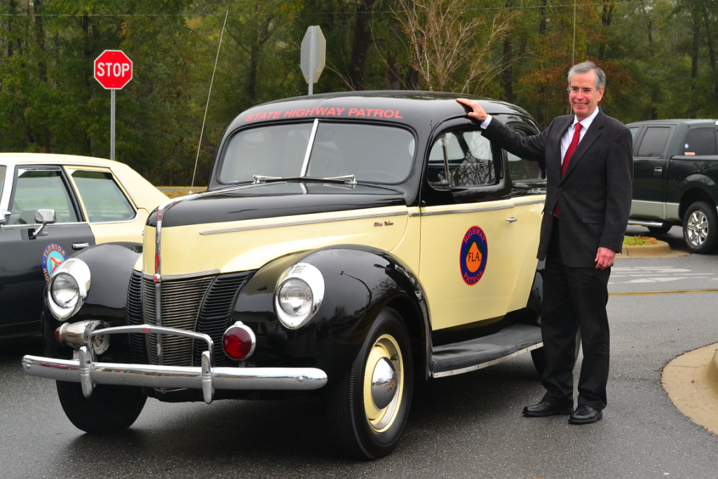 David Neil Kirkman next to old trooper car