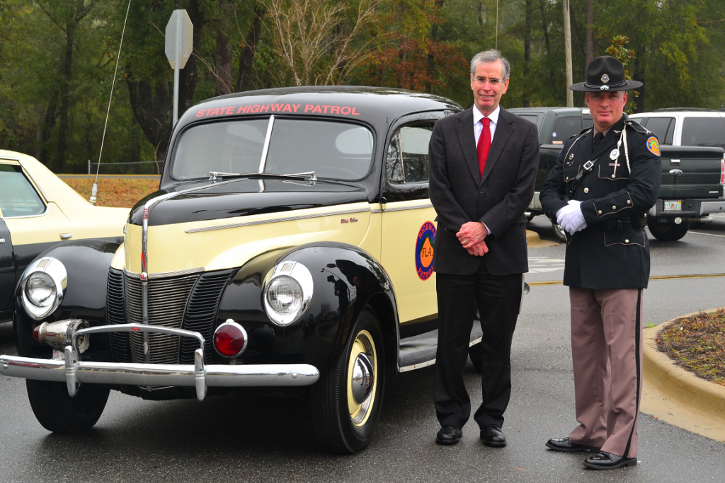 David Neil Kirkman next to old trooper car