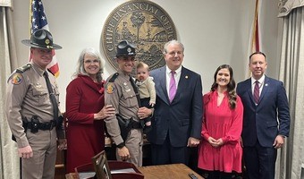 Trooper Turner with his wife, mother and son.