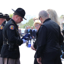 FHP Colonel Howze II giving flag to family.