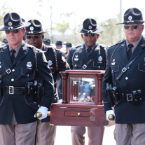 Troopers carrying Trooper Fink's urn.