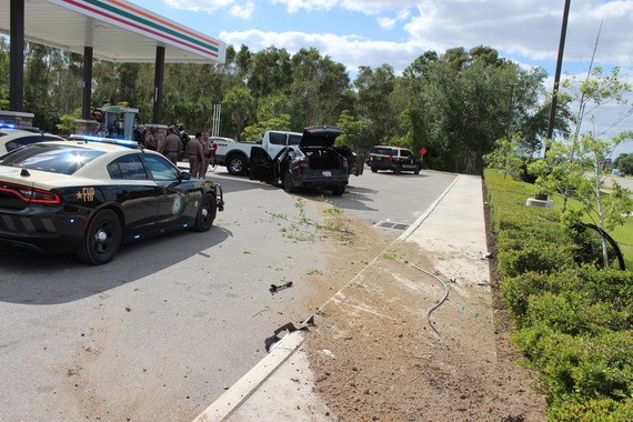 Suspects car shown crashed into pickup truck after running over bushes