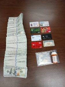 Confiscated money, IDs and drugs