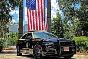 Trooper vehicle in front of American flag