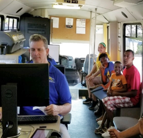 Customers receiving service in mobile driver license bus